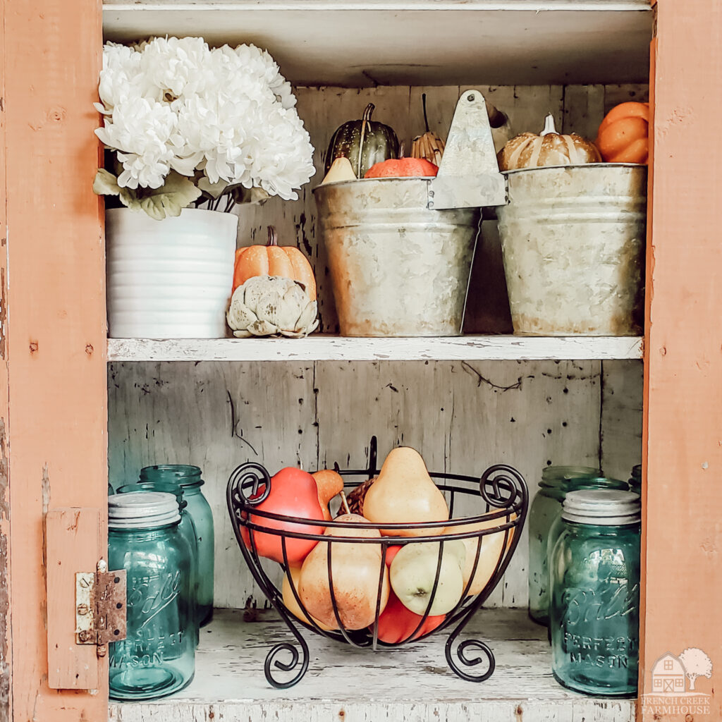 Vintage cupboard decorated for fall