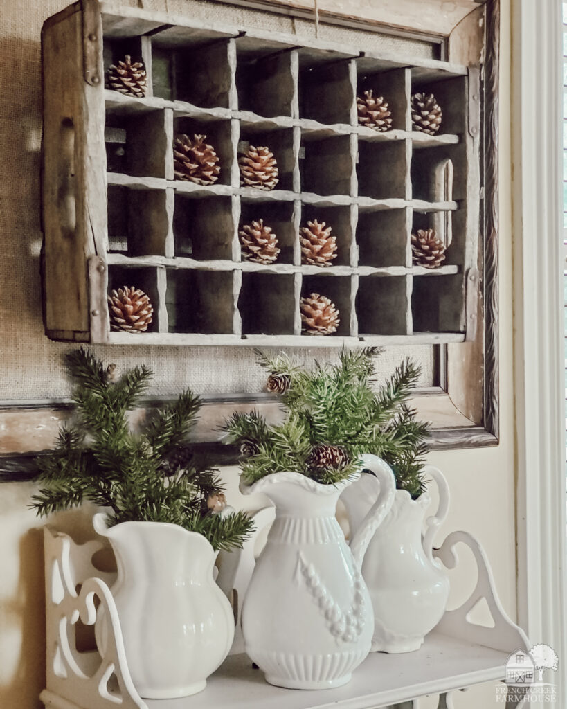 A soda crate makes wonderful winter wall decor with pine cones!
