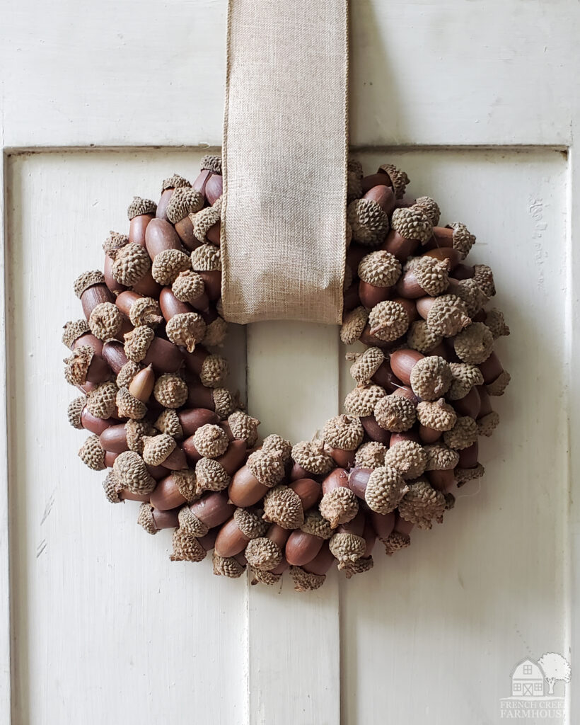 Making your own autumn wreath from natural elements like acorns offers a perfect fall touch