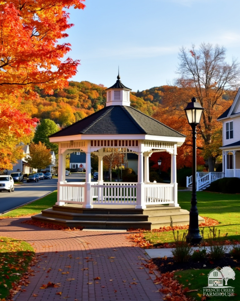 A white gazebo in town center during autumn